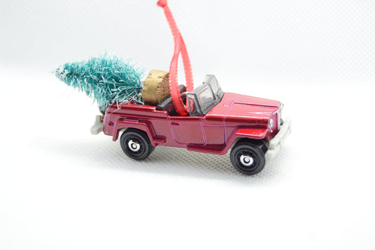 Vintage maroon Jeepster ornament with festive tree and red ribbon