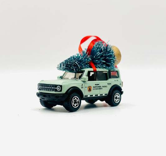 Model car with a Christmas tree on a white background