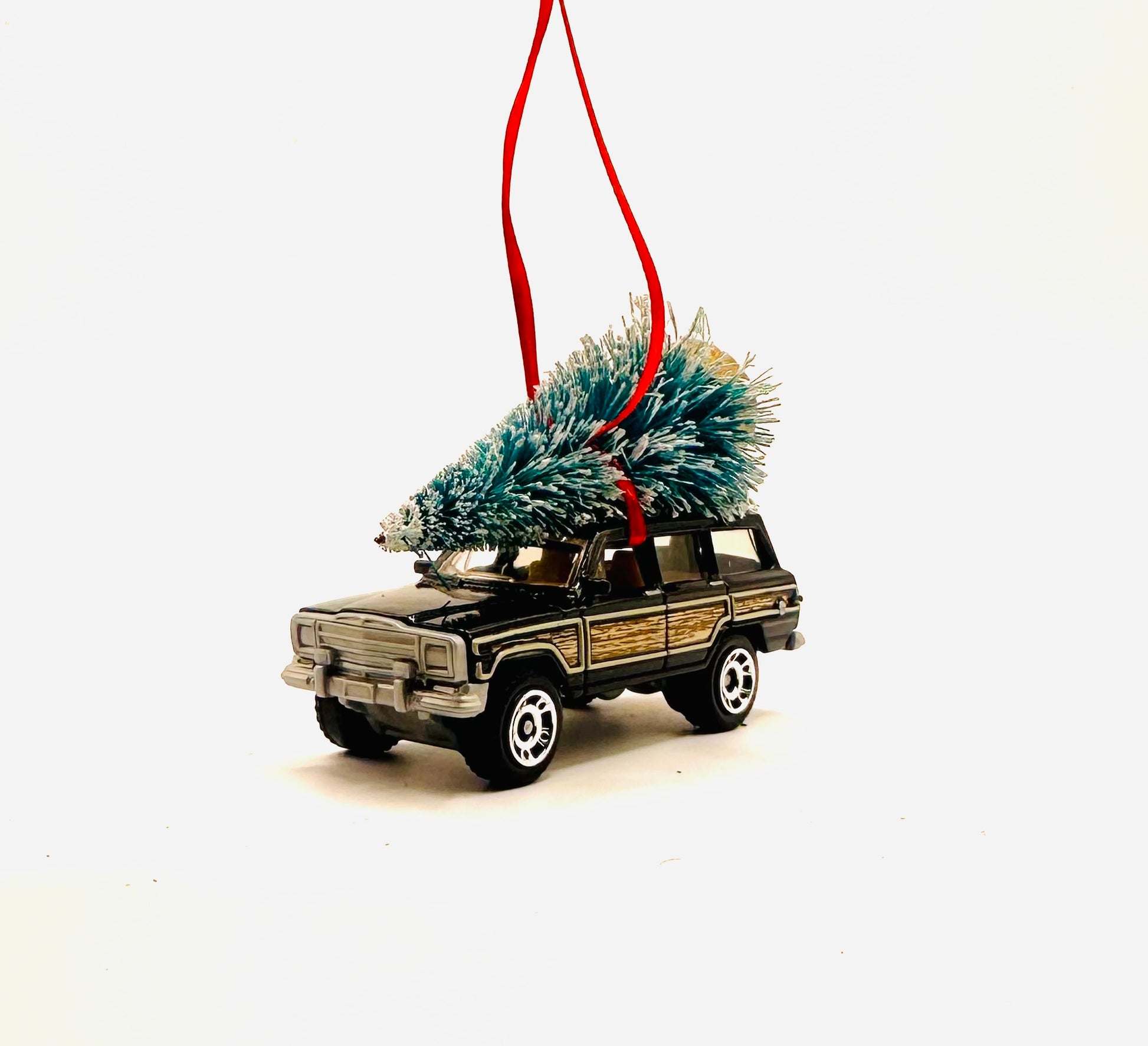 Model diecast Jeep wagoneer toy with tree made into a ornament