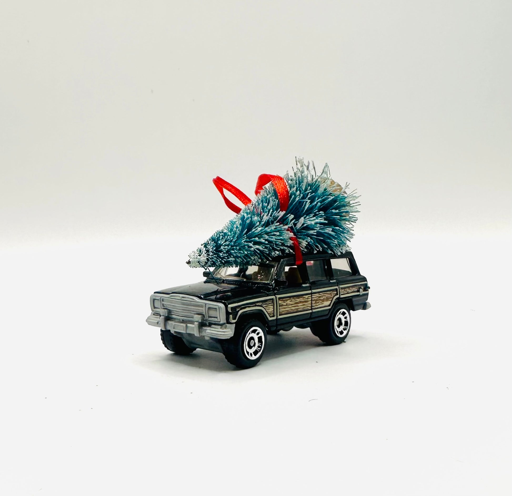 Jeep Wagoneer Green diecast toy with a tree ornament on a white background