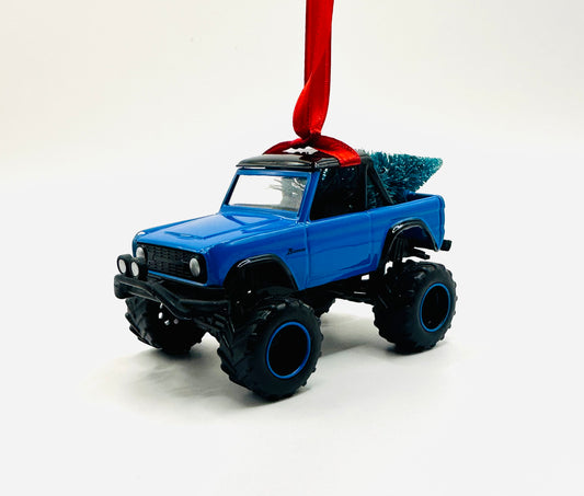 Blue Ford Bronco lifted ornament with oversized tires and festive tree