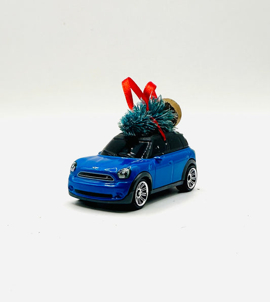 Blue toy car with a Christmas tree on a white background