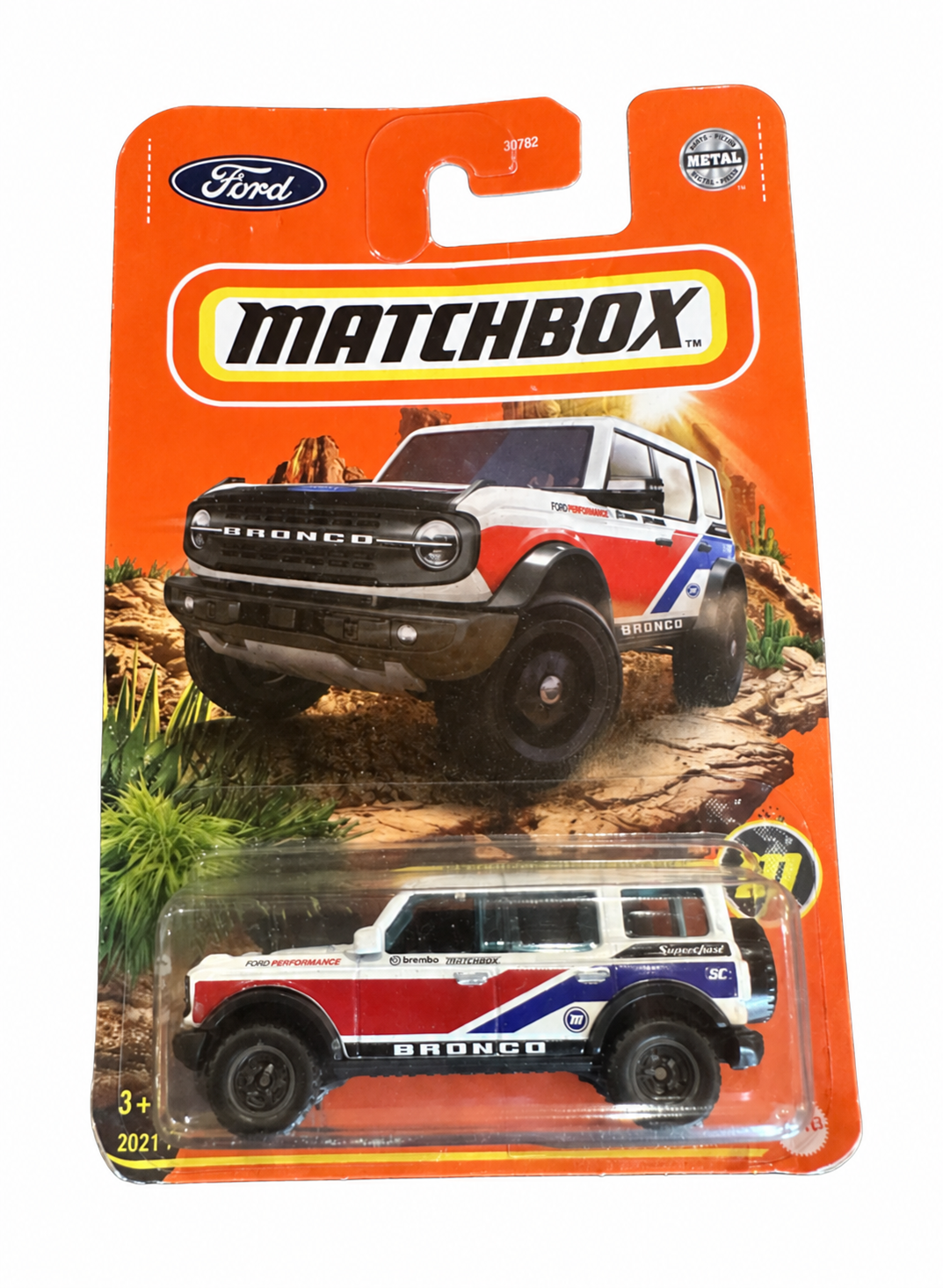 Matchbox Super Chase 2021 Ford Bronco in white, red and blue with black wheels, in original orange blister packaging — Offroad Collectibles.