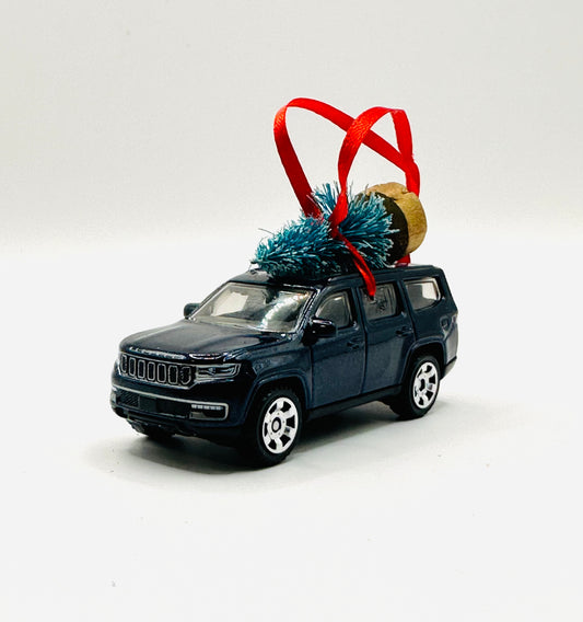 Model SUV Jeep Wagoneer with Christmas tree and ornament on a white background