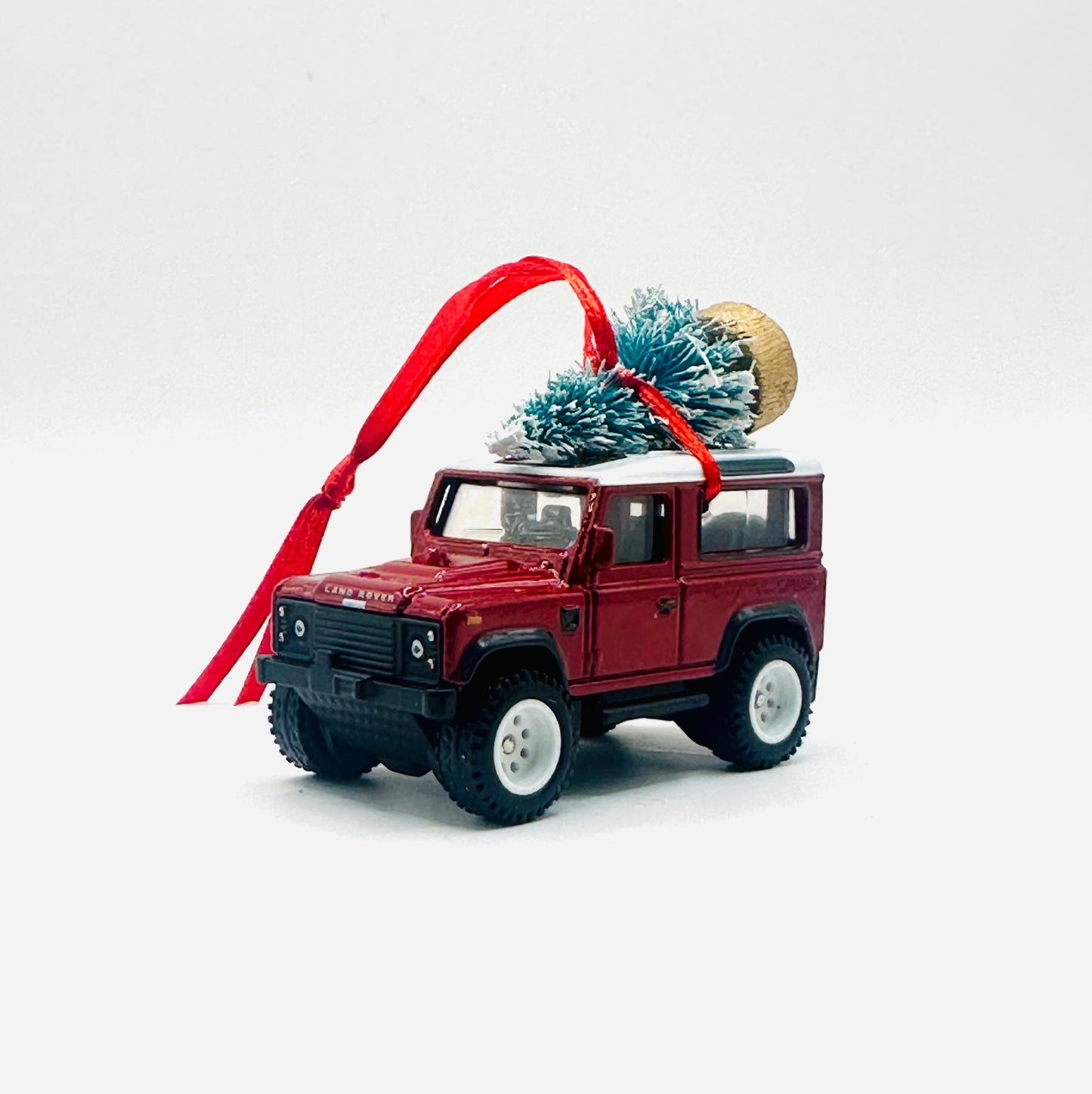 Model car with Christmas decorations on a white background