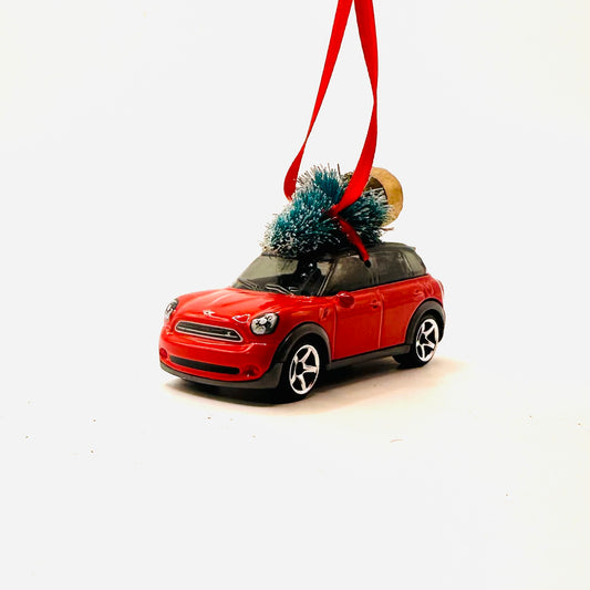 Red car ornament with a small Christmas tree on a white background