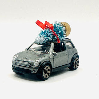 Silver Mini Cooper diecast car ornament with Christmas tree and red ribbon - front angle view
