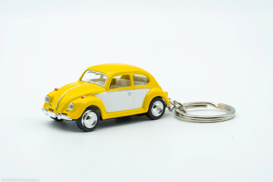 Yellow and white VW Beetle diecast keychain with metal keyring